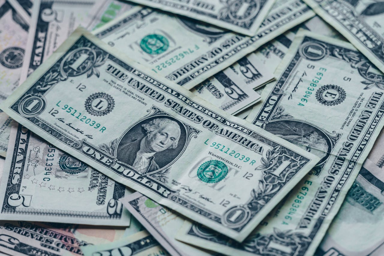 Close-up image of stacked US dollar bills representing wealth and finance.